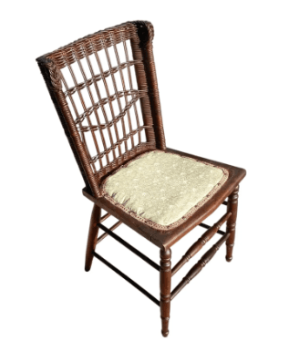 A dark wood and wicker side chair with an upholstered seat. The chair features a high backrest with an intricate woven wicker pattern, resembling spindles, and turned wooden legs with stretchers. The seat is a padded cushion covered in a light-colored, subtly patterned fabric with decorative trim. — 3D model