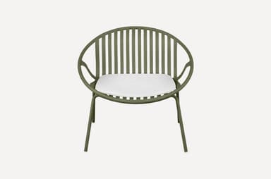 A modern armchair with a rounded, slatted back and seat, featuring a minimalist design. The frame is constructed from slender metal tubing, and it includes a white cushion for comfort. The chair is supported by four thin legs. — 3D model
