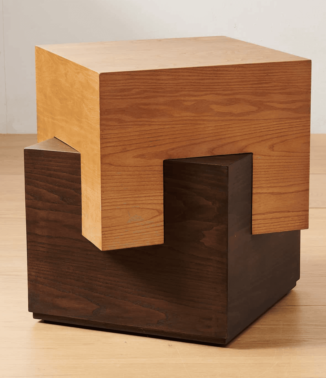 A unique end table with a cube-like design, featuring two distinct wooden blocks. The upper block is lighter in color and appears to interlock or rest on the darker, lower block. The construction suggests a modern or contemporary aesthetic. — 3D model