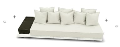 A contemporary, low-profile sofa with a modular design. It features a white base frame and a large, flat seat cushion. Several rectangular, off-white throw pillows are arranged against the back. A dark brown, rectangular side table is attached to the left side of the sofa. The overall aesthetic suggests an outdoor or lounge setting. — 3D model