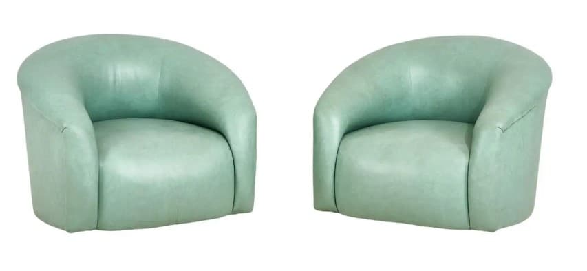 A compact, fully upholstered club chair featuring a barrel-shaped back and integrated armrests. The chair is covered in a smooth, light mint green material, likely faux leather or a soft-touch fabric, with a tight seat cushion. — 3D model