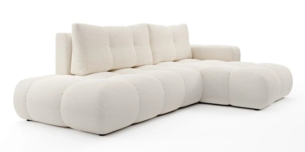 An L-shaped contemporary sectional sofa upholstered in a cream-colored boucle fabric. The design features soft, rounded edges on the base and armrests, creating a plush and inviting appearance. The seating and back cushions have a subtle tufted or channeled detail, emphasizing the modular construction. It sits low to the ground on small, inconspicuous feet. — 3D model