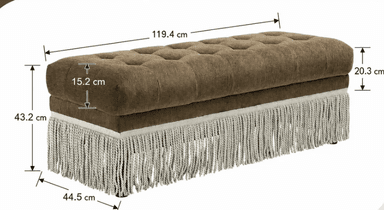 A rectangular upholstered bench featuring deep button tufting on the top surface and a decorative fringe trim along the bottom edge. The main body is covered in a textured brown fabric, and the fringe is a lighter, possibly cream or light grey, textile. The bench appears to sit on small, concealed feet. — 3D model
