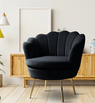 A contemporary accent chair featuring a distinctive scalloped backrest upholstered in plush navy blue velvet. The chair has a barrel-like form with a rounded seat and is supported by four slender, tapered metal legs with a polished gold finish. — 3D model