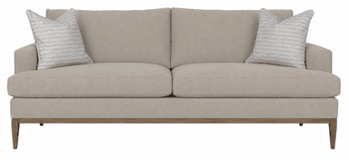 A two-seater sofa with a neutral beige fabric upholstery. It features two throw pillows with a black and white geometric pattern. The sofa has a low-profile design with a visible wooden base and tapered legs, suggesting a modern or mid-century modern style. — 3D model