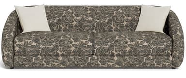 A contemporary sofa fully upholstered in a dark beige and grey botanical pattern fabric. It features a streamlined form with gently rounded track arms and two loose seat cushions. The sofa comes with two light-colored square toss pillows. — 3D model