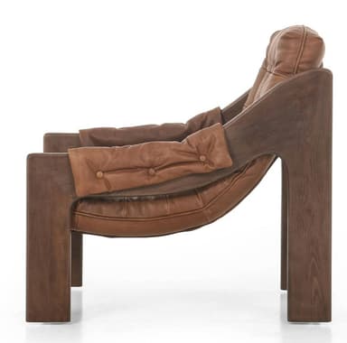 A tufted armchair featuring a wooden frame and brown leather upholstery. The frame has a distinct organic shape with curved elements. The seat and back cushions are deeply tufted with prominent buttons, and the armrests are padded and covered in leather. The overall design suggests a mid-century modern or contemporary style. — 3D model