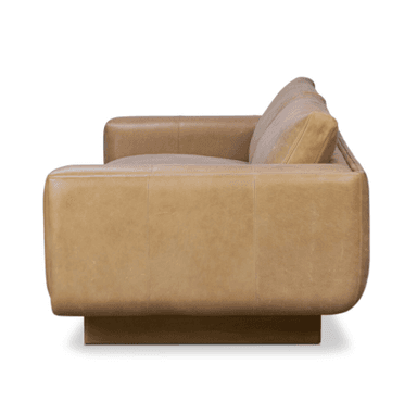 A modern two-seater sofa upholstered in tan leather, featuring clean lines, thick cushions, and subtly rounded arm details, supported by recessed dark wood block legs. — 3D model