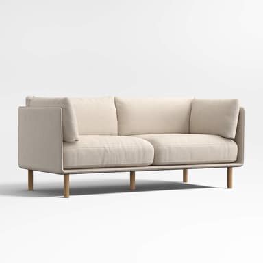 A two-seater sofa with clean lines and a minimalist design. It features a low profile, squared armrests, and plush cushions for the seat and back. The sofa is elevated by four slender, cylindrical wooden legs. — 3D model