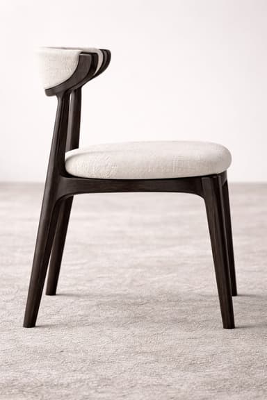 A contemporary dining chair featuring a dark-stained solid wood frame and light beige fabric upholstery. The chair has a curved backrest that integrates smoothly with the frame, and a padded, square seat. The four legs are tapered, contributing to its modern and elegant silhouette. — 3D model