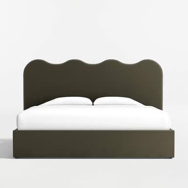 A bed frame with a scalloped headboard and a platform base. The headboard has a curved, wavy top edge. The bed frame is upholstered and appears to have storage drawers integrated into the base, with distinct panel lines visible on the front and sides. White bedding, including a sheet and two pillows, is present on the mattress. — 3D model