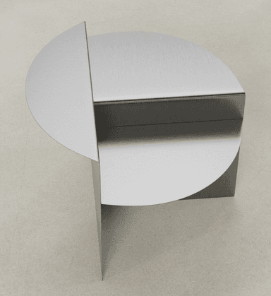 A modern end table with a unique geometric design. It features a circular top surface partially overlapping a rectangular body, with a single vertical support. The overall construction appears to be made of metal with a brushed finish. — 3D model