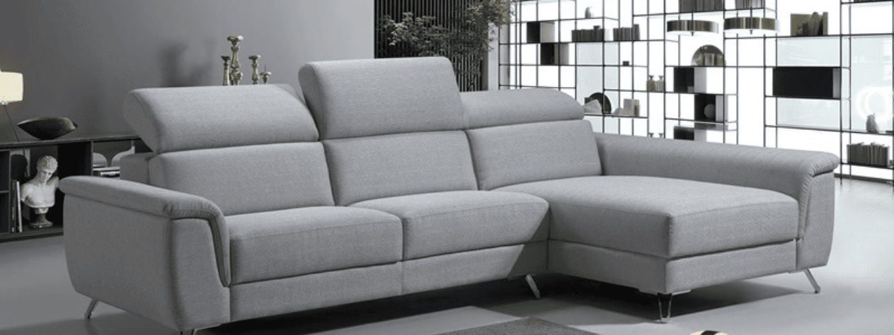 A modern sectional sofa with a chaise lounge extension. The sofa features multiple seat cushions, adjustable headrests, and is upholstered in a light gray fabric. It is supported by slender, angled legs. — 3D model