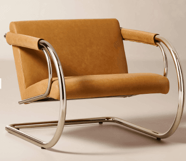 A tan leather cantilever lounge chair featuring a polished chrome tubular steel frame and Bauhaus-inspired design. The seat, back, and armrests are upholstered in tan leather, creating a sleek and modern appearance. — 3D model