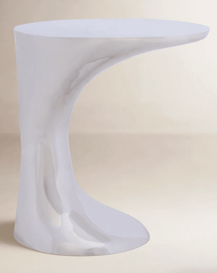 A white, glossy accent table with a distinctive, asymmetric, sculptural form. The table features a smooth, continuous surface that flows from the base to the tabletop, creating a fluid, organic silhouette. — 3D model