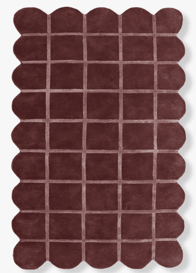 A rectangular rug with a scalloped edge and a grid-like pattern created by raised, lighter-colored lines. The pile appears to be medium-length and plush. — 3D model
