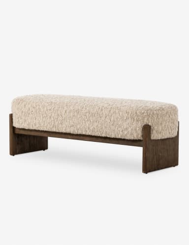 A long, upholstered bench with a textured, boucle-like fabric in a neutral off-white color. The bench features a solid, dark wood frame with a minimalist design. The frame consists of two horizontal pieces connecting the legs, which have a subtle, angled profile. — 3D model