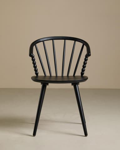 A contemporary armchair featuring an all-black finish. It has a curved spindle backrest that flows into integrated armrests. Distinctive spherical turned details adorn the ends of the armrests where they meet the seat. The seat is a flat, subtly contoured disc, supported by four splayed and tapered legs. — 3D model