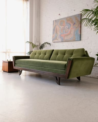 An olive green Mid-Century Modern sofa featuring a button-tufted backrest and an exposed dark wood frame that forms the base and partially frames the sides. — 3D model