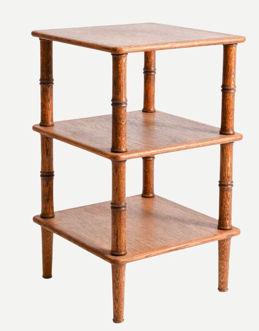 A square, three-tiered wooden side table featuring turned column legs with decorative bamboo-like detailing. The table is finished in a warm, medium brown stain, showcasing the wood grain. Each of the three square shelves provides a flat surface, with the legs extending to form the support structure. — 3D model