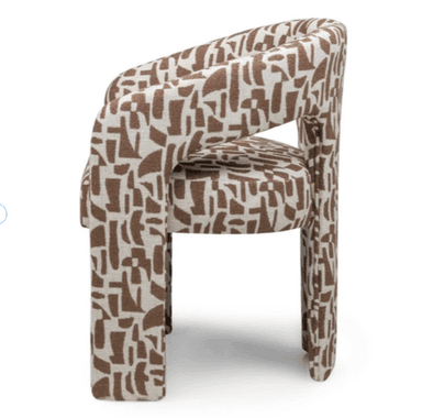 A fully upholstered armchair featuring a continuous, curved barrel-shaped backrest and integrated armrests. The chair is covered in a fabric with a distinctive brown and white abstract geometric pattern. Its base and legs are also upholstered, giving it a monolithic and sculptural appearance. — 3D model