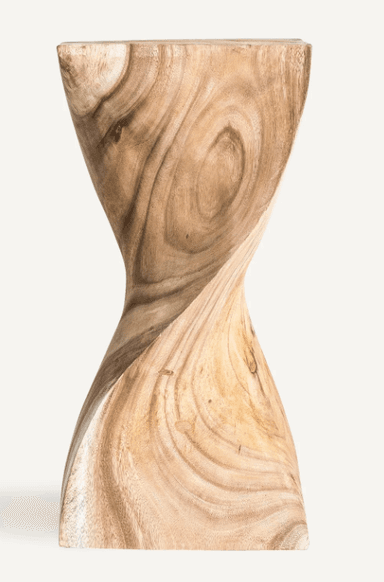 A solid wood accent piece, crafted from light-toned wood with prominent grain. It features an hourglass-like, twisted sculptural form, wider at the top and bottom and narrowing in the middle. The natural finish highlights the organic patterns of the wood. — 3D model