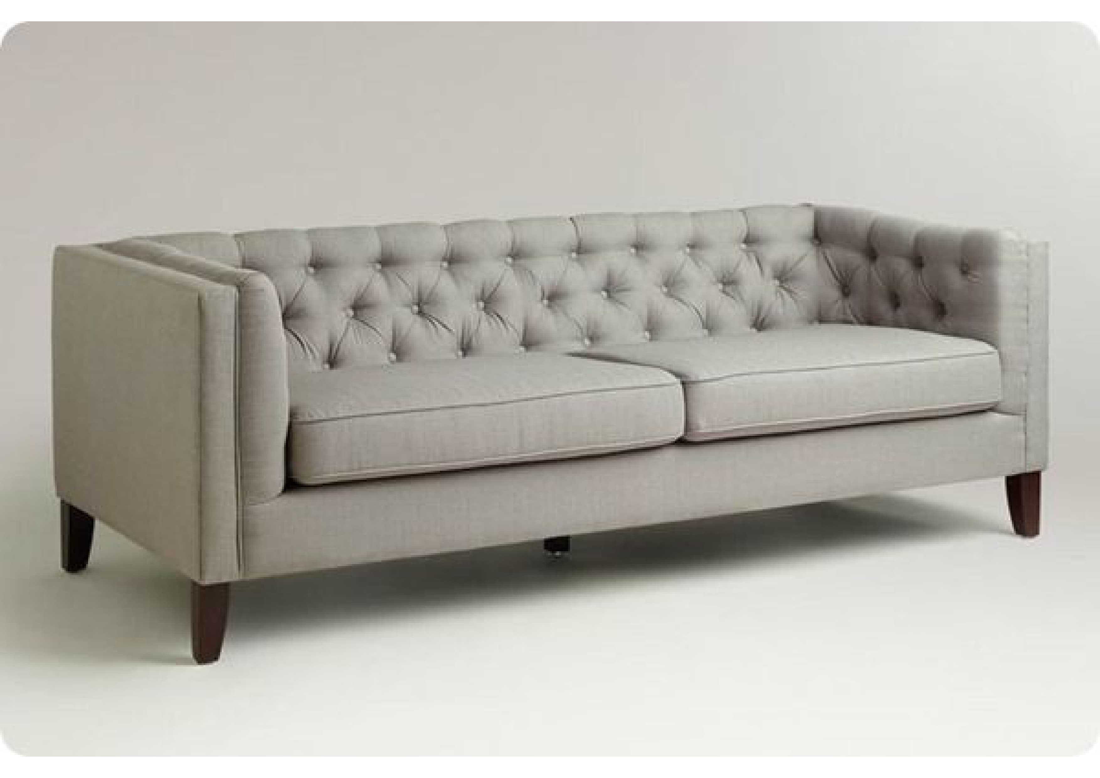 A contemporary two-seater sofa featuring a deep button-tufted backrest, sleek track arms, and two removable seat cushions. It is upholstered in a light grey fabric and stands on four dark, tapered wooden legs. — 3D model