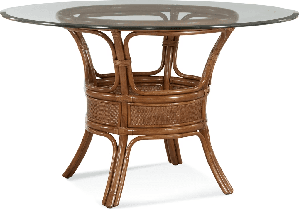 A round dining table with a glass top and a rattan base. The base features a central cylindrical section with woven detailing, supported by four curved legs. — 3D model