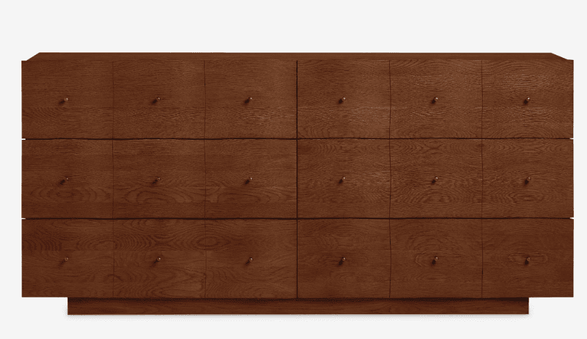 A long, low, rectangular wooden credenza or sideboard with a warm, medium-brown finish and visible wood grain. The front facade is composed of multiple individual panels, each fitted with a small, circular brass knob. The unit sits on a recessed plinth base, giving it a sleek, minimalist appearance. — 3D model