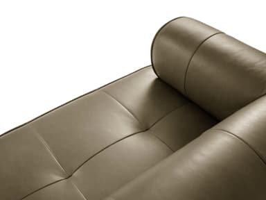 A modern chaise lounge sofa with a tufted seat cushion and a rounded armrest/headrest. The sofa features clean lines and a low profile, upholstered in a smooth, matte-finish material. — 3D model