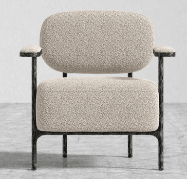 A single accent chair with a textured, bouclé upholstery on the seat, back, and armrests. The frame and legs are made of dark metal with a visible hammered texture. — 3D model
