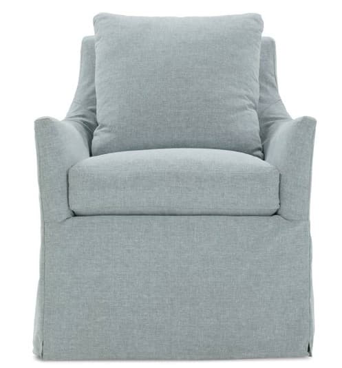 A slipcovered armchair with a loose, relaxed fit. It features a plush seat cushion and a large back cushion, with flared arms and a skirted base that drapes to the floor. — 3D model