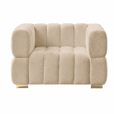 A plush, cream-colored armchair with a distinctive channel-tufted design. The upholstery has a textured, boucle-like finish. The chair features rounded armrests and a deep seat. It is supported by two low-profile, rectangular brass feet. — 3D model