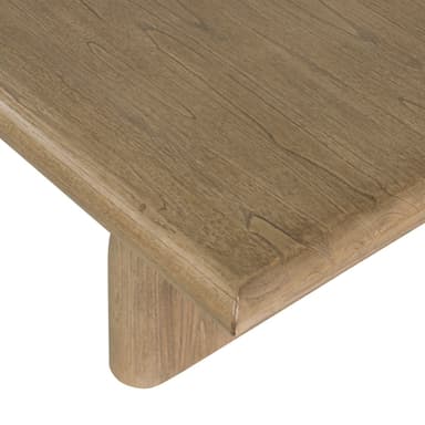 A low rectangular coffee table with a thick, rounded top and two sturdy, cylindrical legs positioned towards the ends of the table. The piece has a minimalist design and appears to be made from solid wood. — 3D model
