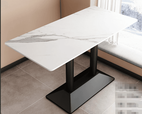 The image displays a contemporary rectangular table featuring a white top with grey faux marble veining and a contrasting black metal twin pedestal base. The tabletop has subtly rounded corners, presenting a sleek and modern aesthetic. The base consists of two robust cylindrical columns affixed to a rectangular, slightly trapezoidal plinth, providing stable support. The overall design emphasizes clean lines and a minimalist profile, suitable for various modern interiors. — 3D model