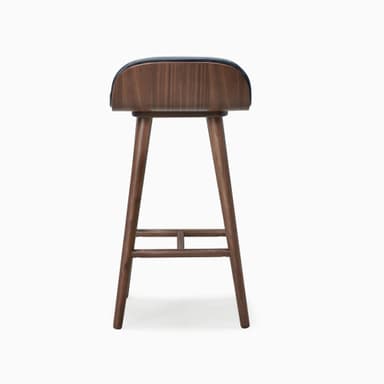 A modern bar stool featuring a black upholstered seat and backrest, supported by a splayed dark walnut wood frame with integrated footrests. — 3D model