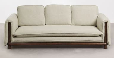 A light-colored, textured upholstered loveseat with wide, squared block arms, loose back and seat cushions, and a minimalist exposed dark wood base with short legs. — 3D model