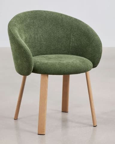 A contemporary dining armchair featuring a dark green, textured upholstered seat and back, with integrated armrests forming a continuous, rounded bucket shape. The chair is supported by four natural light-toned wooden legs that taper slightly downwards. The overall design suggests a comfortable yet minimalist aesthetic, suitable for modern interiors. — 3D model