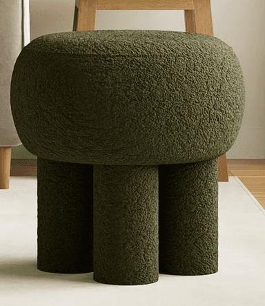 A compact, modern pedestal stool fully upholstered in a textured olive green bouclé fabric. It features a rounded, spherical top supported by three robust, cylindrical legs that blend seamlessly into the seat structure, creating a monolithic and sculptural form. — 3D model