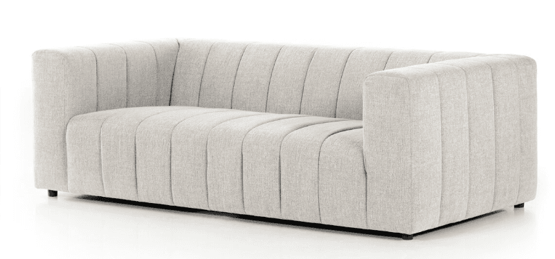 A contemporary three-seater sofa with a light-colored, textured fabric upholstery. The sofa features a channeled design on the backrest, seat, and arms, creating vertical pleats. It has a low profile with squared arms and a solid base. — 3D model