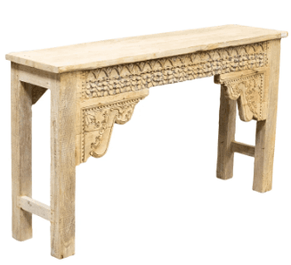 A distressed, light-colored wooden console table with ornate carvings along the apron and decorative brackets supporting the tabletop. The legs are straight and feature a crossbar for stability. The overall aesthetic suggests a rustic or antique style. — 3D model