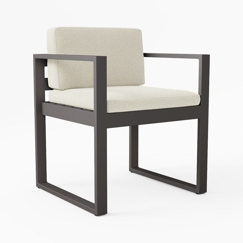 A modern armchair characterized by a dark-colored metal frame with a rectangular profile, featuring integrated armrests and sled-style base legs. It is fitted with separate, plush light beige fabric cushions for both the seat and back. — 3D model