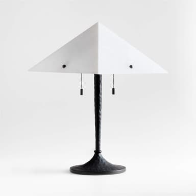 This is a contemporary table lamp featuring a distinctive pyramidal, frosted acrylic shade. The shade is held by two black finials and illuminates downwards. The lamp's stem is dark, possibly black metal, with a textured, almost twisted appearance, tapering upwards from a substantial, hammered-texture round base. It includes two black pull chains for operation, suggesting individual bulb control. — 3D model