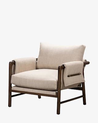 A modern lounge chair featuring an exposed dark-finished metal or wood frame supporting thick, light-beige fabric upholstery in a relaxed, sling-style design. The chair includes a padded backrest and seat cushion, with a horizontal bar detail visible on the rear securing the fabric. — 3D model