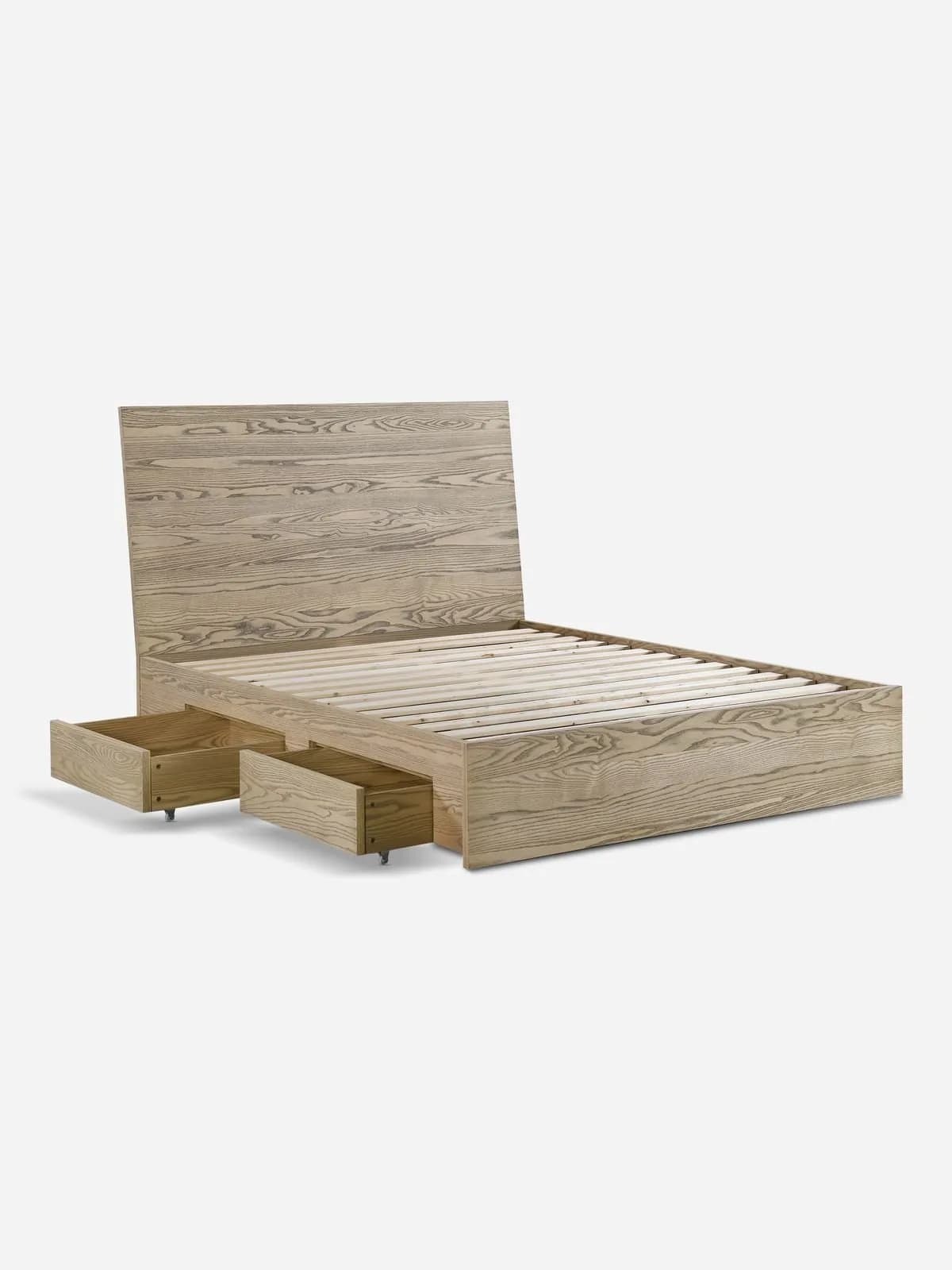 A wooden bed frame with an integrated headboard and two pull-out drawers at the foot of the bed. The bed frame features a slatted base for mattress support and a natural wood grain finish. The headboard is upright and rectangular, while the main frame has a low profile. — 3D model