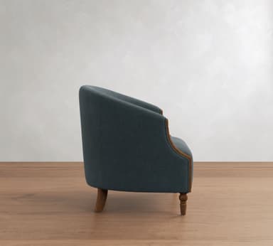 A blue-grey upholstered barrel-back accent chair with exposed dark wood trim and turned legs, featuring a curved silhouette and textured fabric. — 3D model