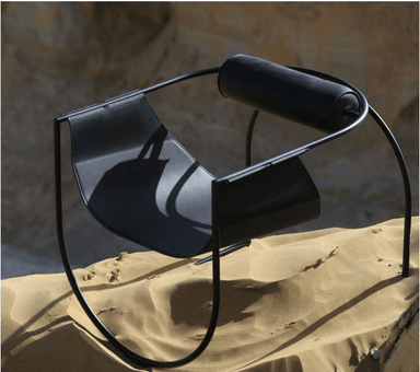 A contemporary black chair with a minimalist design. It features a curved, seat-like structure made of flat metal, supported by thin, black metal tubing that forms the legs and frame. A cylindrical element, possibly a backrest or armrest, is integrated into the upper part of the frame. — 3D model