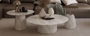 A contemporary coffee table featuring a round white marble top supported by a substantial cylindrical pedestal base with a vertical fluted texture. — 3D model