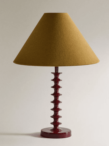 A table lamp featuring a red lacquered spindle base and a mustard yellow conical fabric shade. The base consists of multiple stacked, turned wooden elements, creating a distinctive profile, resting on a circular foot. — 3D model