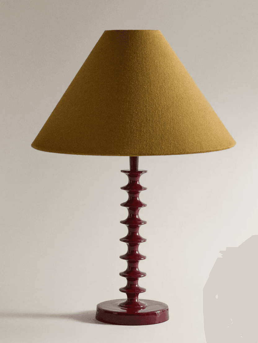 A table lamp featuring a red lacquered spindle base and a mustard yellow conical fabric shade. The base consists of multiple stacked, turned wooden elements, creating a distinctive profile, resting on a circular foot. — 3D model